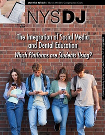 Four young people leaning against wall looking down at phones