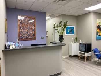 dental reception area with desk and waiting chairs