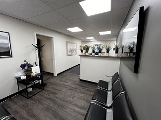 dental office waiting room with chairs and front desk